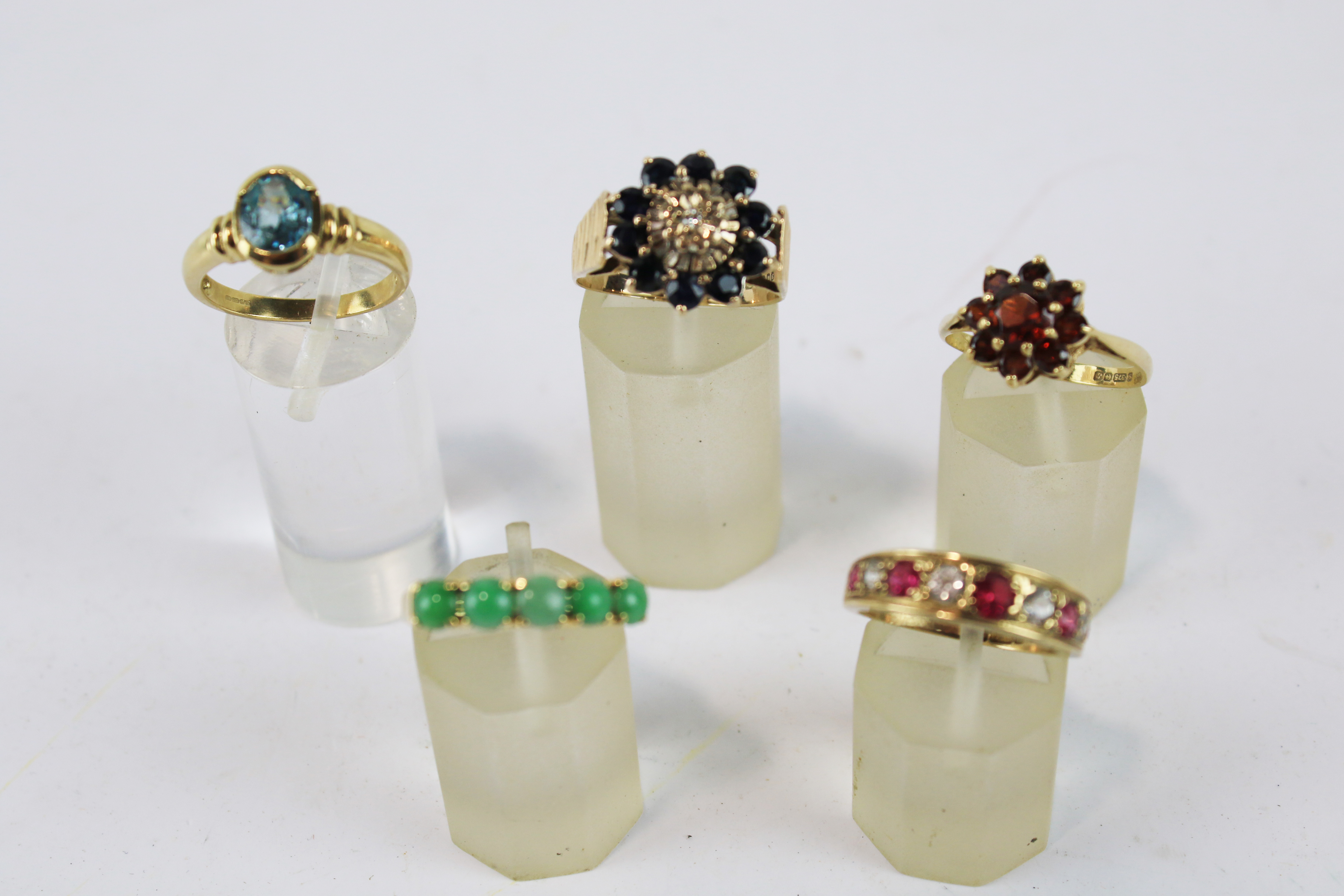 A jadeite five stone ring and four vintage 9ct gold and gem rings;