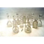 An assortment of cut and other glass decanters.