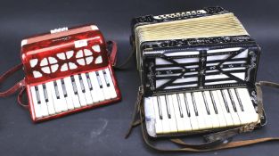 Two accordions by Mariani of Germany in black and Chanson.in red.