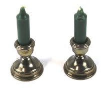 A pair of Elizabeth II squat silver candlesticks.