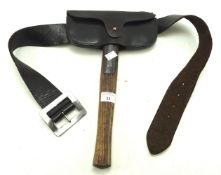 A vintage fireman's axe with leather case and matching belt.