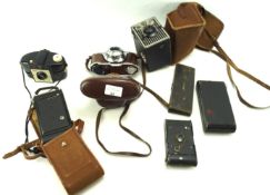 An assortment of cameras and other items.