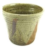 A Marianne de Trey stoneware planter. Glazed in green with geometric shapes, H21.