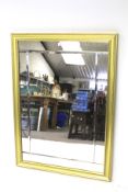 A modern large gilt framed wall mirror. The mirror made up of five pieces with bevelled edges.