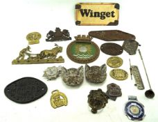 An assortment of metal signs and badges.