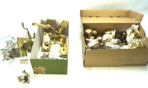 An assortment of brass and other door knobs and hinges.