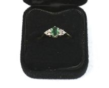 A 9ct gold, emerald and diamond dress ring.