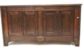 A large mid-century oak sideboard with carved details.