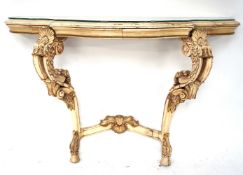 A painted carved contemporary console table with glass top.