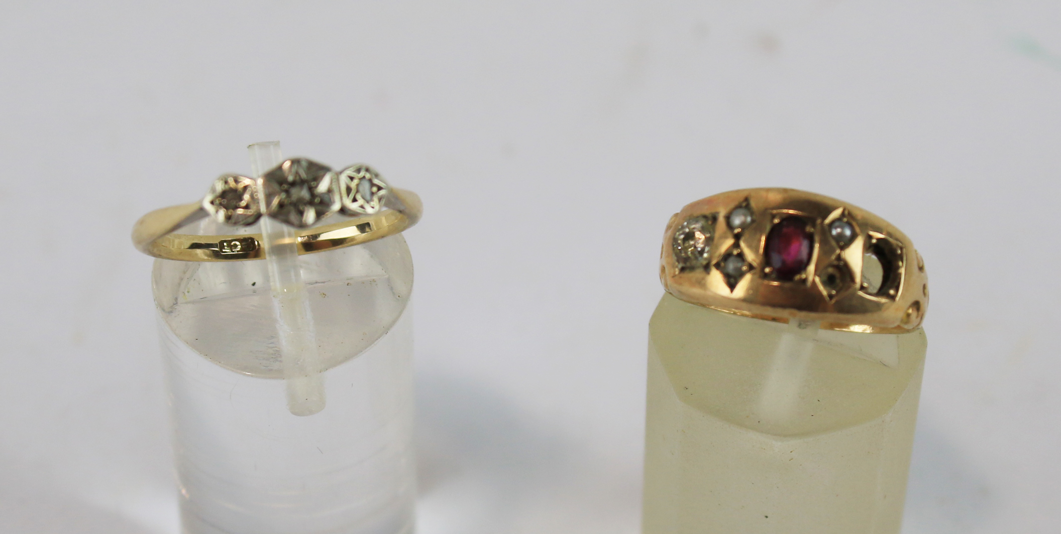Two 9ct gold rings. One with three illusion set white stones,