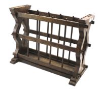 An oak Arts and Crafts magazine rack. With pierced sides and shaped supports.