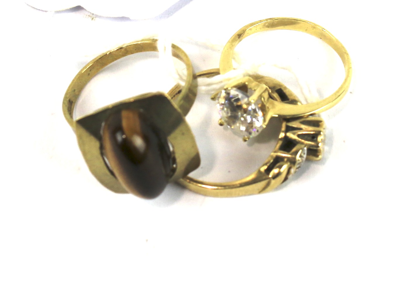 A 9ct gold diamond set ladies ring and two yellow metal rings.