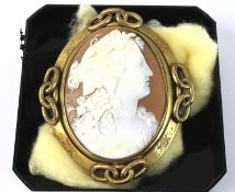 A Victorian gilt metal and shell cameo oval locket-back brooch.