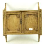 A small early 20th century oak wall cabinet.