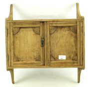 A small early 20th century oak wall cabinet.