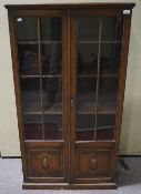 A mid century stained oak display cabinet.