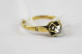 An unmarked yellow metal diamond solitaire ring.