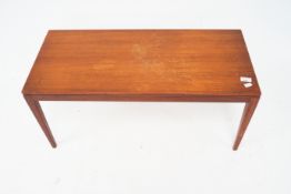 A 1960's teak coffee table. Of rectangular form raised on square tapering supports.