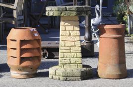 Two terracotta chimney pots and a reconstituted stone bird bath.