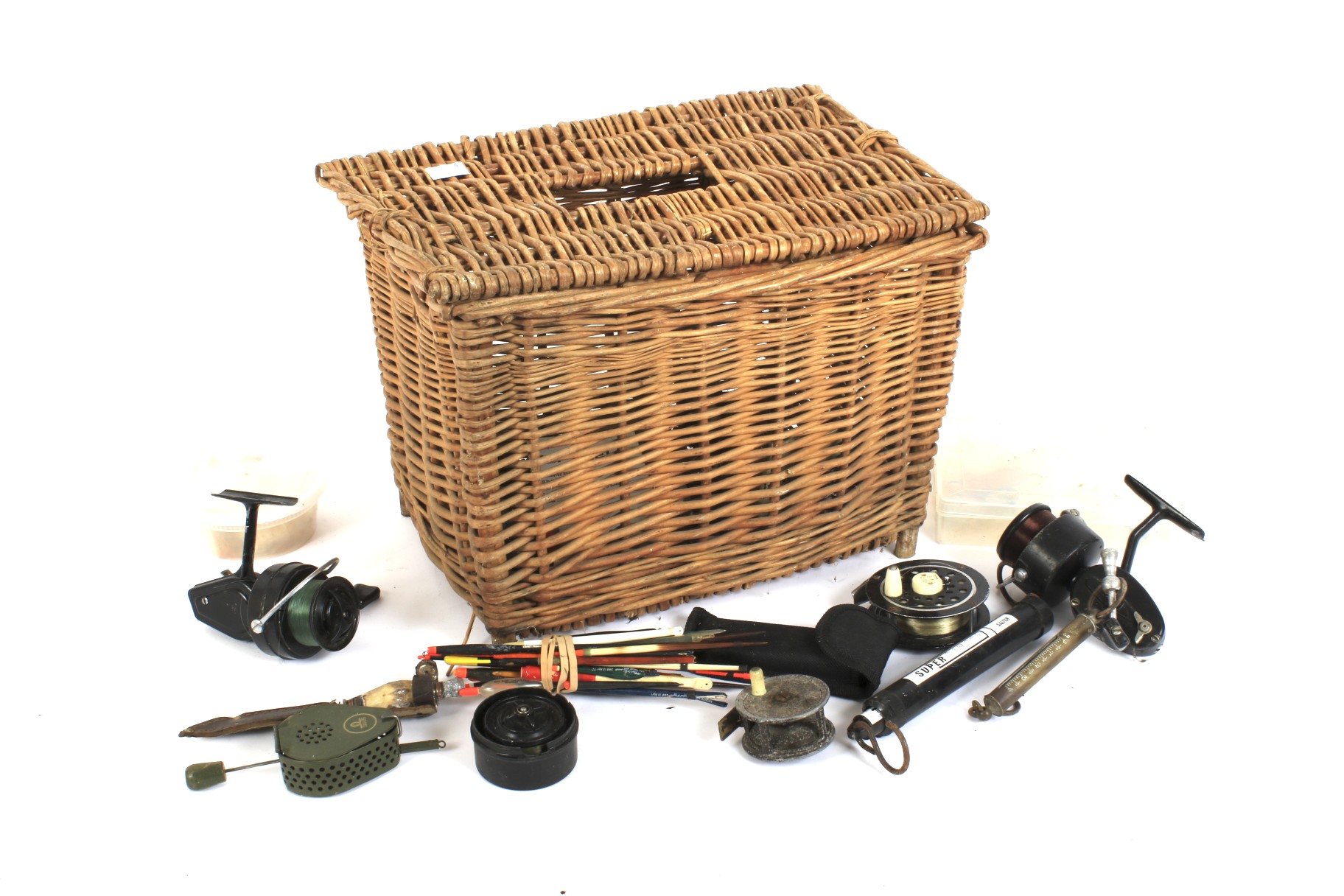 A square wicker basket containing fishing equipment. Including reels, hooks, floats, etc.