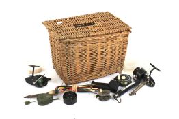 A square wicker basket containing fishing equipment. Including reels, hooks, floats, etc.