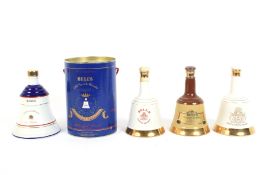 Four Wade decanters of Bells Scotch Whisky. Including commemorative examples.