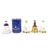 Four Wade decanters of Bells Scotch Whisky. Including commemorative examples.