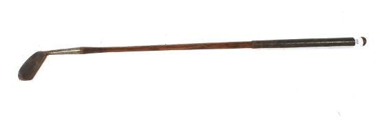 A vintage forged iron golf club with hickory shaft. Marked 'The Orion, James Braid'.