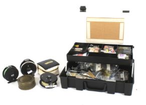 An asssortment of fishing materials in a plastic box.