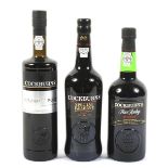 Three bottles of Cockburn's Port.