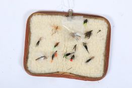 A Barbour brown leather fly wallet with a mixed collection of flies.