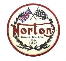 A painted cast iron Norton Motorcycle Company circular plaque.