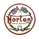 A painted cast iron Norton Motorcycle Company circular plaque.