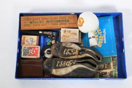 A box of assorted ephemera. Including football boots, playing cards, etc.