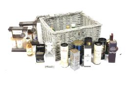 A wicker basket of assorted bottles of whisky.