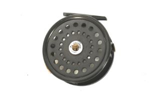 A 3 ½" unbranded wide alloy fly reel.