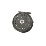 A 3 ½" unbranded wide alloy fly reel.