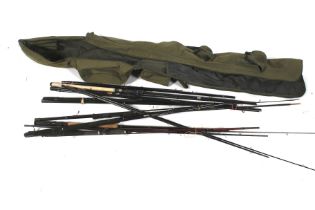 A green rod holdall with a quantity of rods and rod sections.