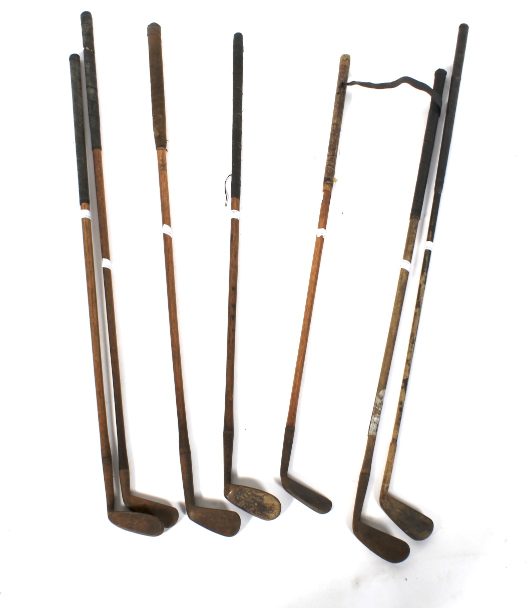 Seven forged iron vintage golf clubs, some with hickory shaft.