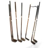 Seven forged iron vintage golf clubs, some with hickory shaft.