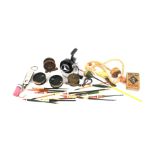 A small assortment of fishing accessories. Including reels, floats, etc.