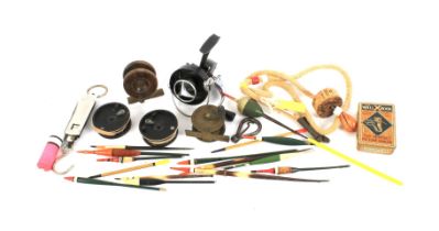 A small assortment of fishing accessories. Including reels, floats, etc.