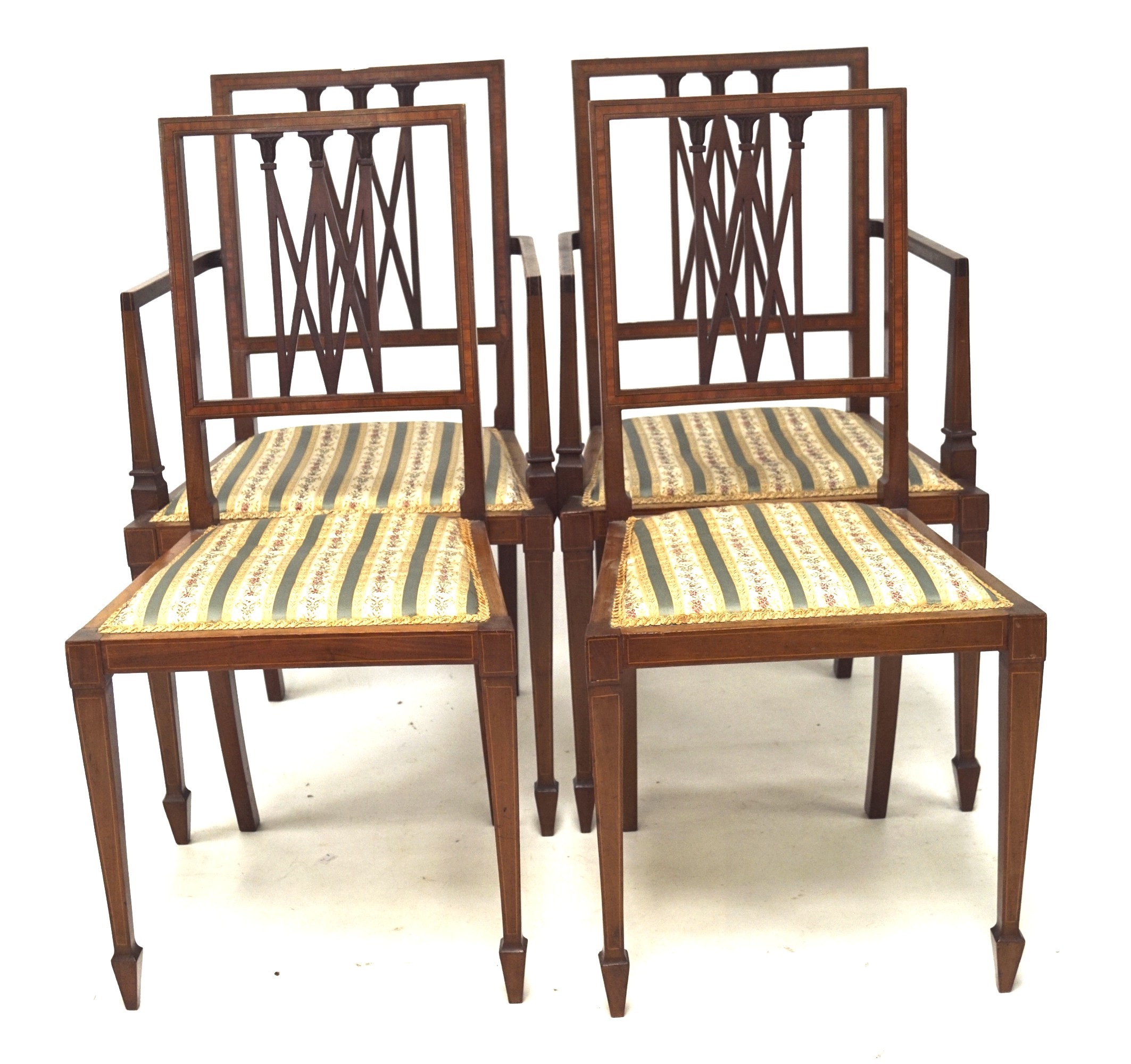 Four Edwardian mahogany dining chairs.