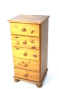 A contemporary pine chest of drawers.