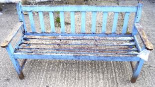 A wooden garden bench. With remnants of pale blue paint.