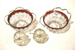 Two sets of glass silver condiment pots.