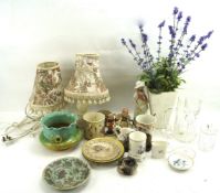 A pair of table lamps and an assortment of ceramics and glass.