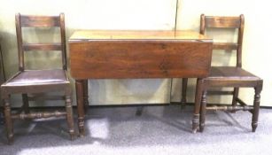 A Victorian mahogany drop leaf table and two dining chairs.