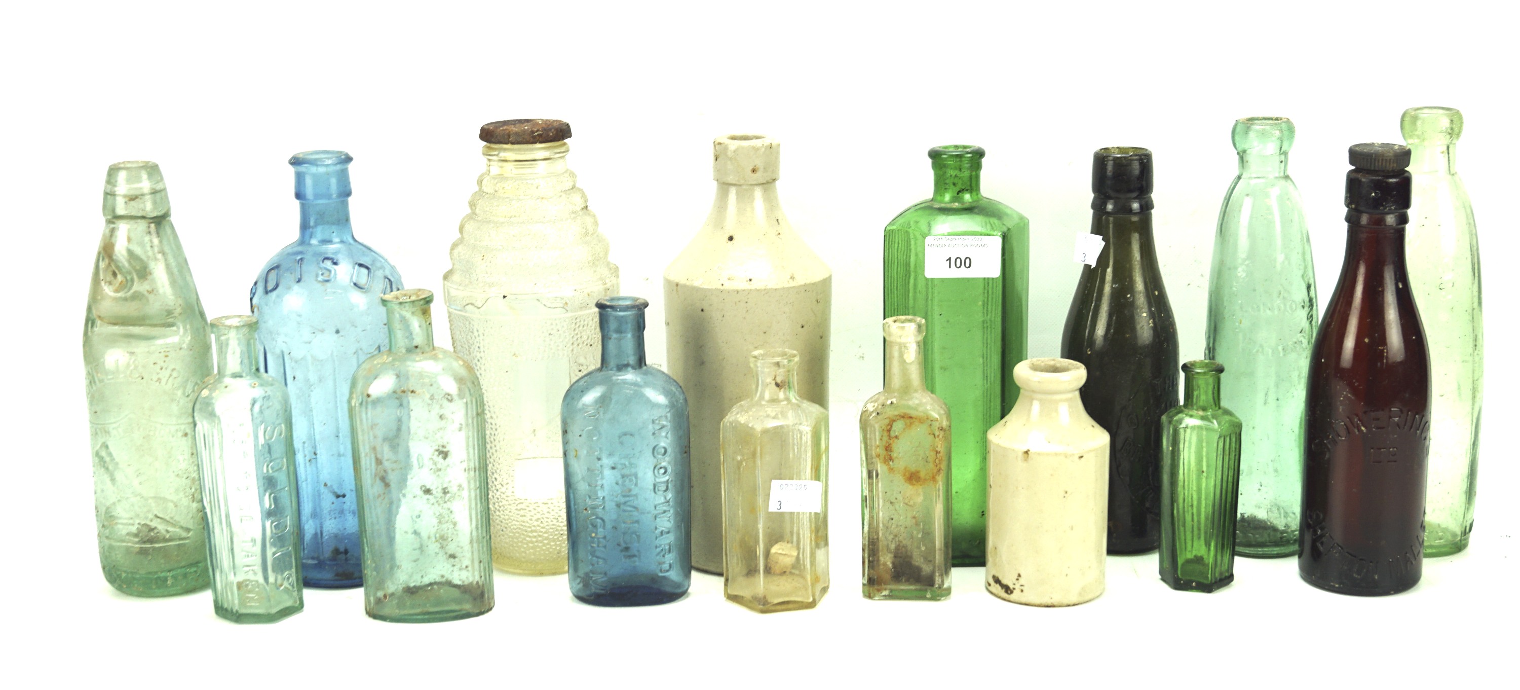 An assortment of vintage glass storage bottles and two ceramic examples.