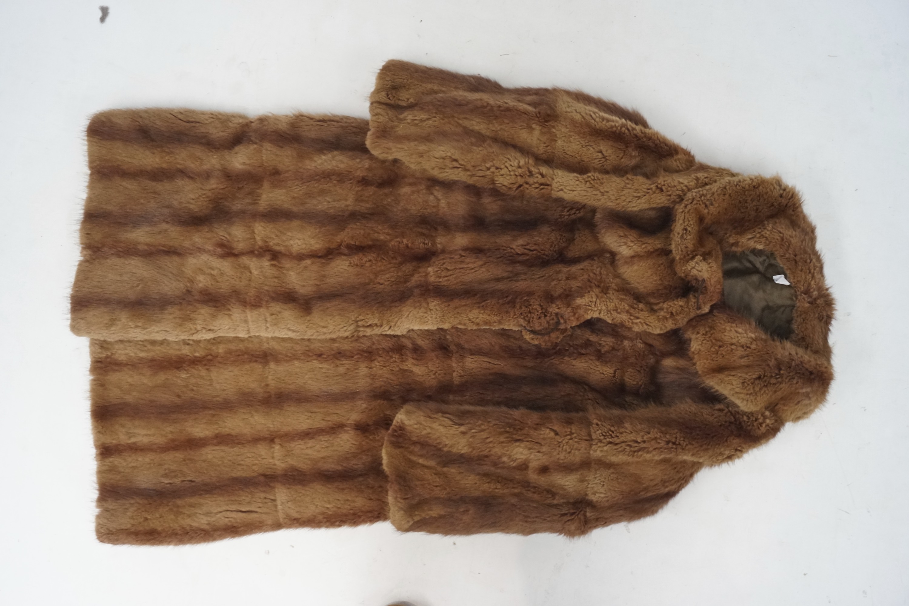 A long brown fur coat, lined.